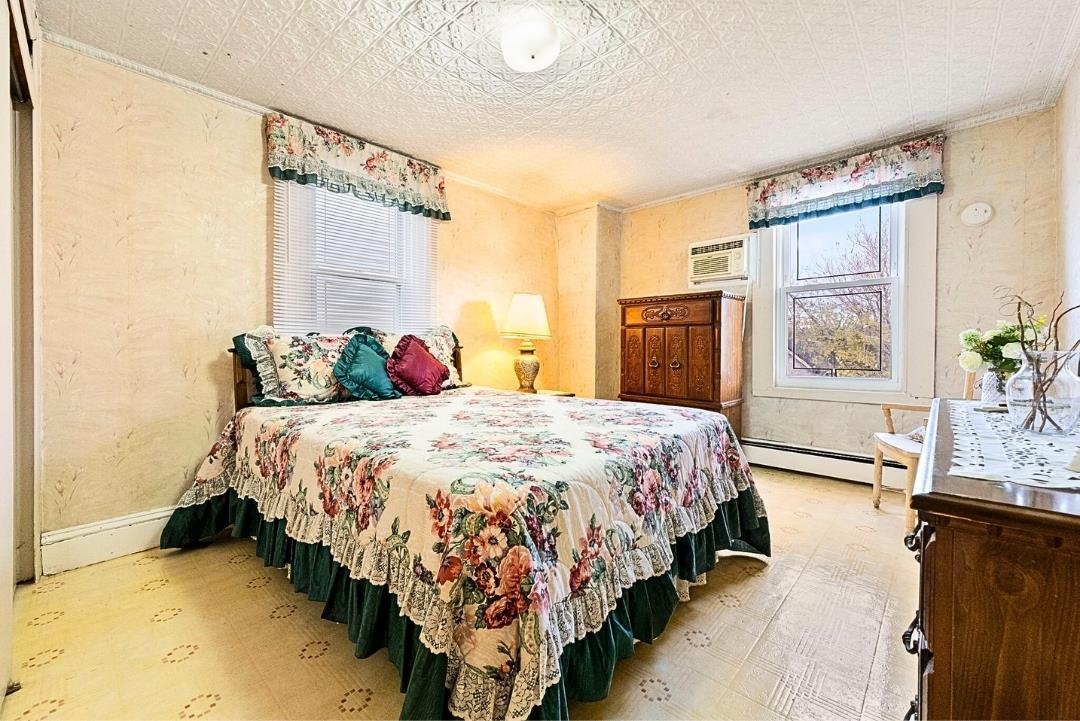 520 27th Street Union City, NJ 07087 - Photo 11 of 19 a bedroom with a bed and wooden floor