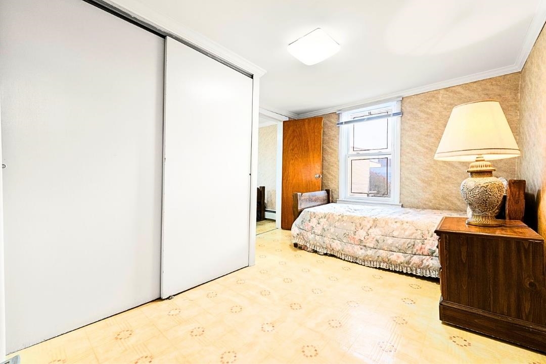 520 27th Street Union City, NJ 07087 - Photo 12 of 19 a bedroom with a bed and a window