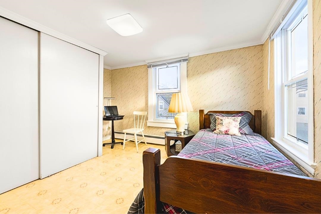 520 27th Street Union City, NJ 07087 - Photo 13 of 19 a bedroom with a bed and wooden floor