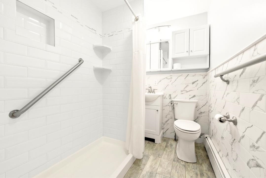 520 27th Street Union City, NJ 07087 - Photo 16 of 19 a bathroom with a toilet and a shower