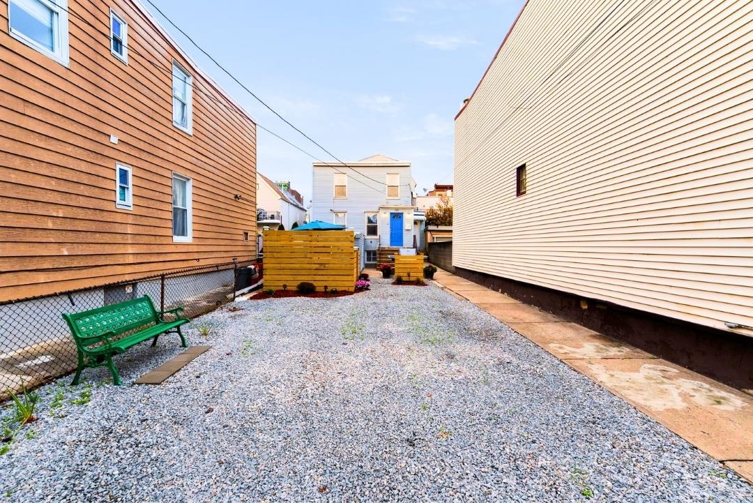 520 27th Street Union City, NJ 07087 - Photo 4 of 19 a backyard of a house with barbeque oven table and chairs