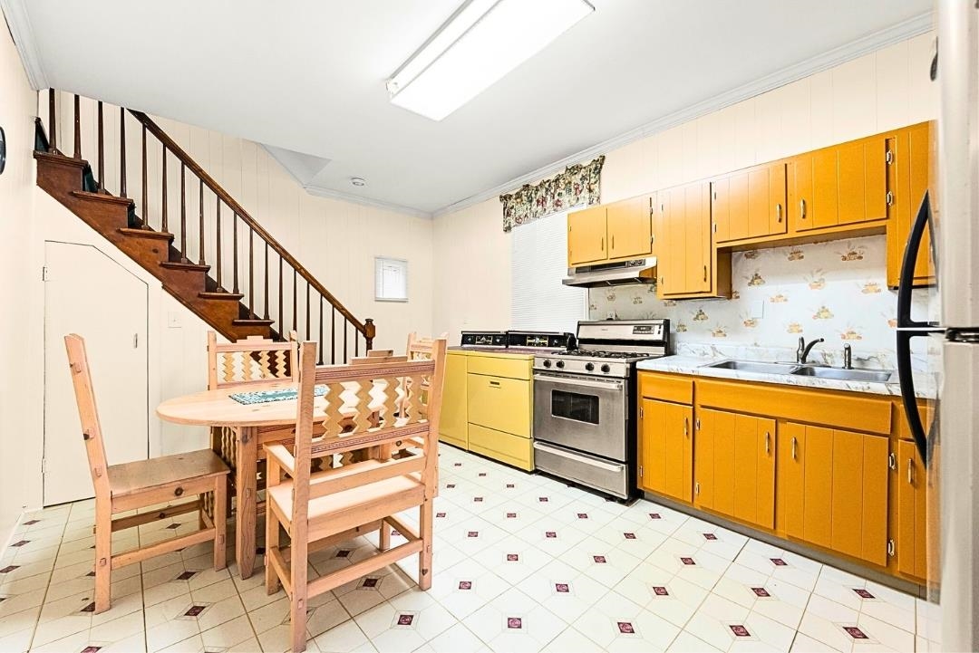 520 27th Street Union City, NJ 07087 - Photo 10 of 19 a kitchen with granite countertop a sink appliances cabinets and furniture