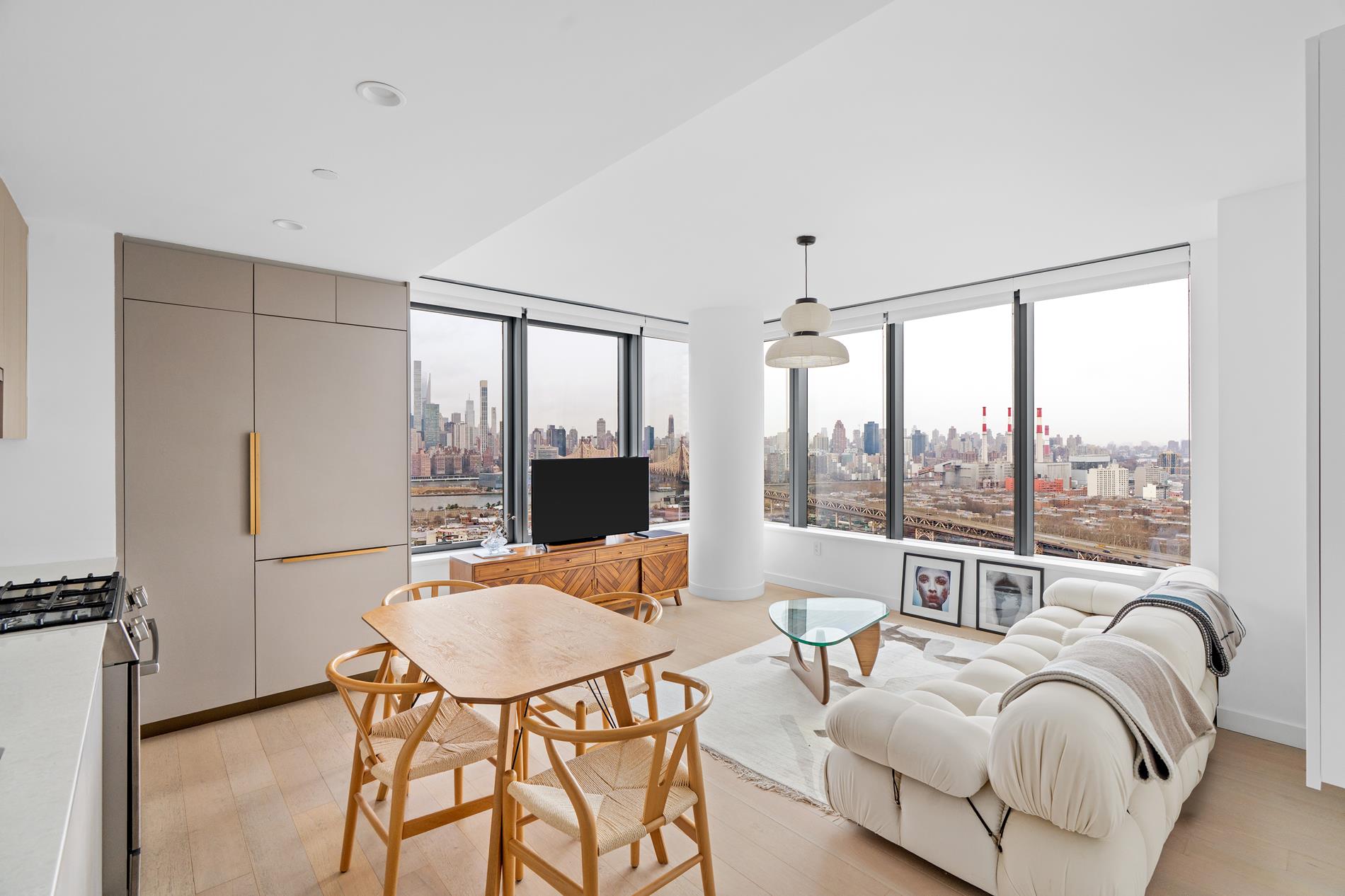3 Court Square, Unit 2902 Queens, NY 11101 - Photo 1 of 12 a living room with furniture and a large window