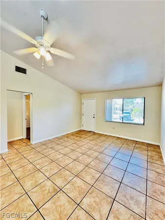 a bedroom with a bed and a ceiling fan