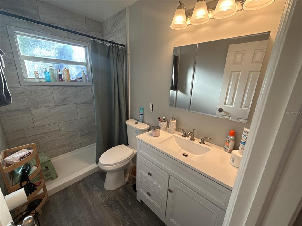 903 North Harbor Terrace Road Tavares, FL 32778 - Photo 15 of 69 a bathroom with a toilet sink and mirror