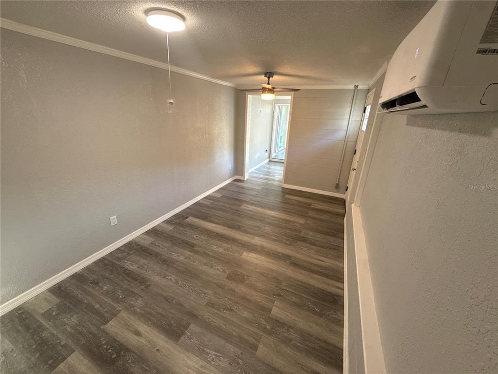 903 North Harbor Terrace Road Tavares, FL 32778 - Photo 40 of 69 a view of empty room with wooden floor and fan