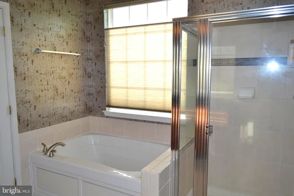 a bathroom with a tub and shower