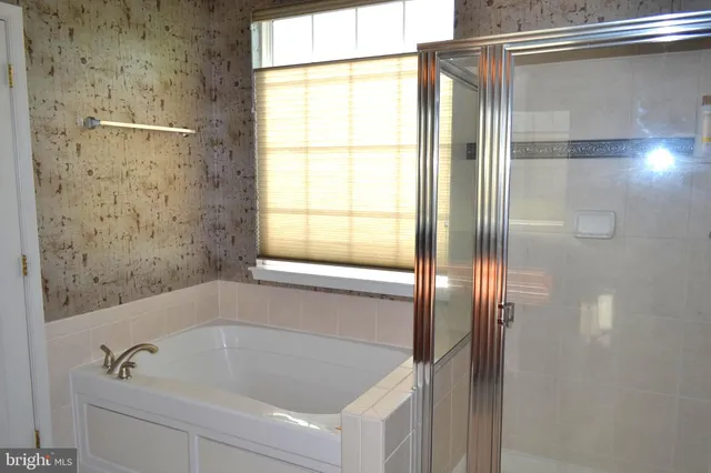 a bathroom with a tub and shower