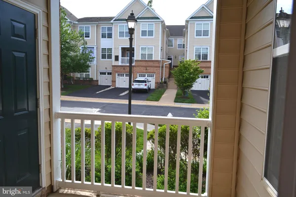 a view of a brick house with a small yard