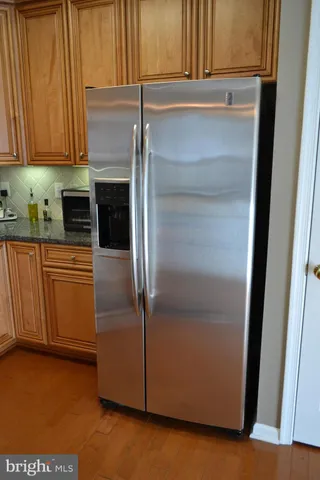 a kitchen with a refrigerator and cabinets