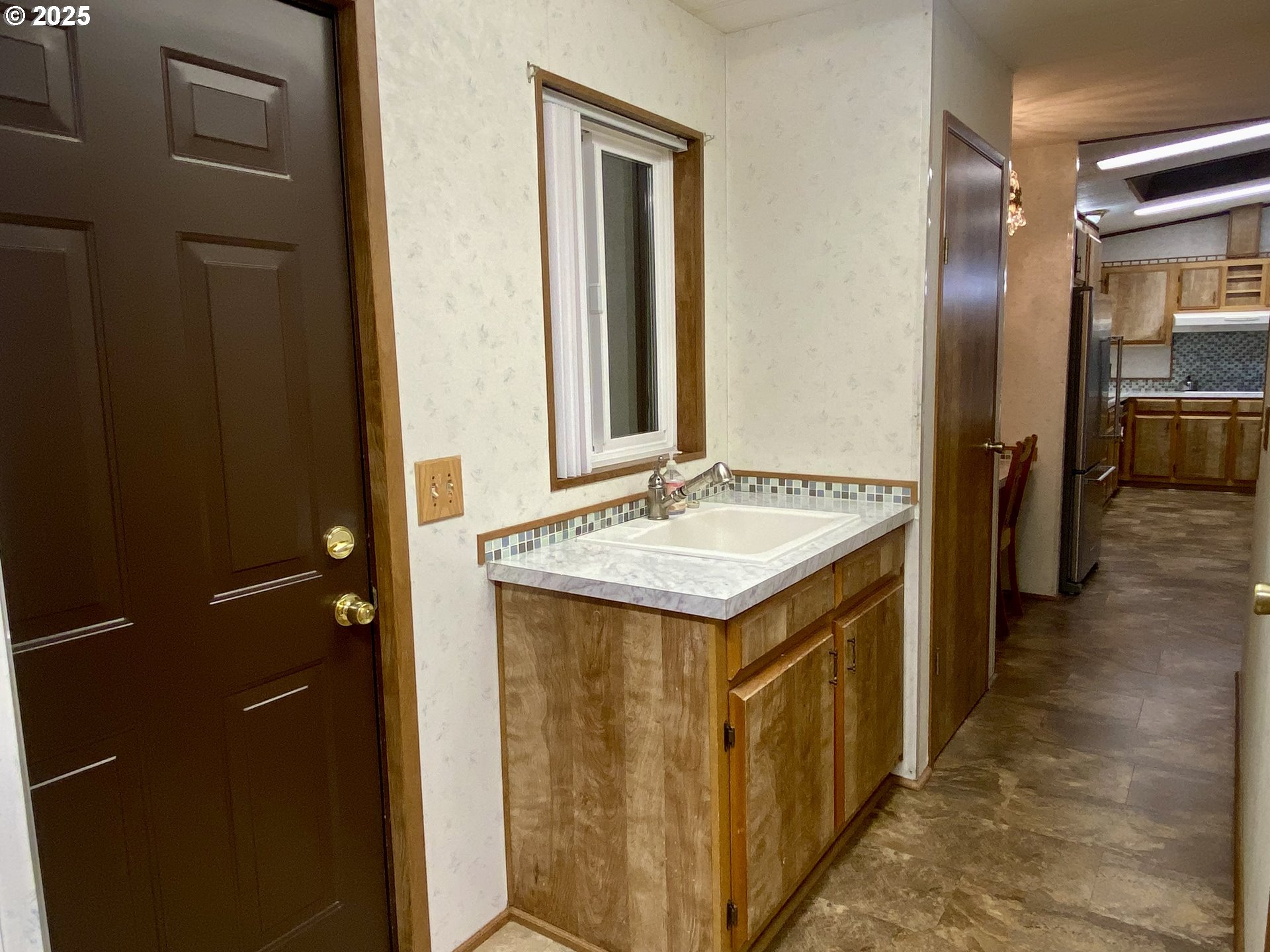 7858 Southeast King Road, Unit 7 Milwaukie, OR 97222 - Photo 28 of 31 a kitchen with a refrigerator and a sink
