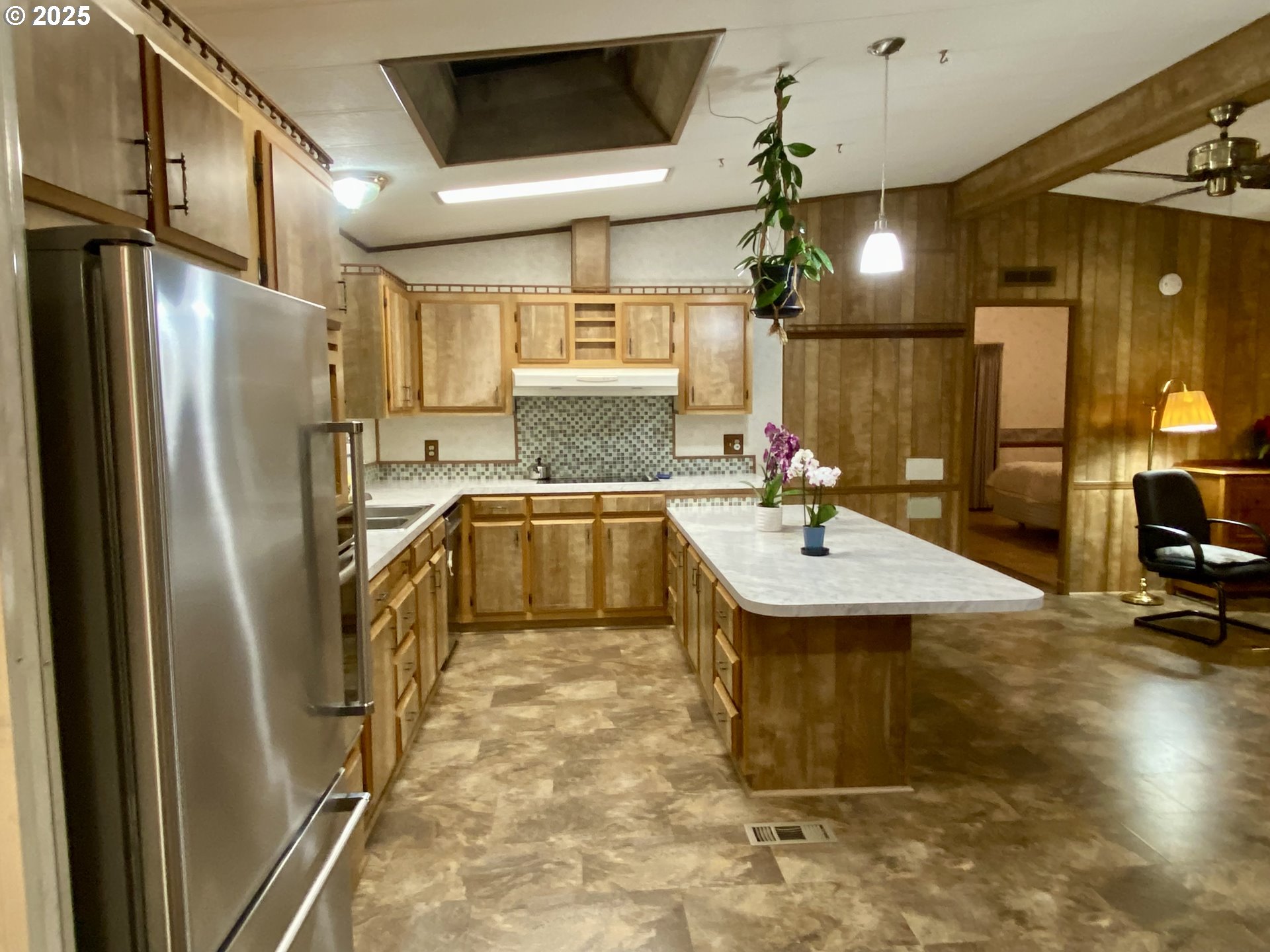 7858 Southeast King Road, Unit 7 Milwaukie, OR 97222 - Photo 29 of 31 a kitchen with a sink refrigerator and cabinets