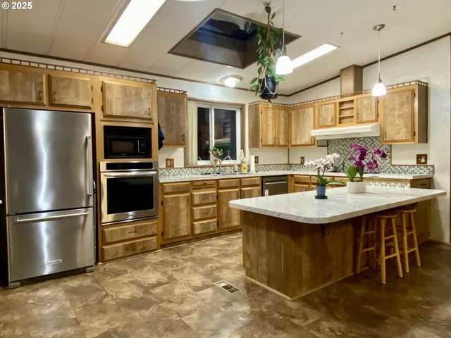 a living room with furniture a fireplace and a chandelier