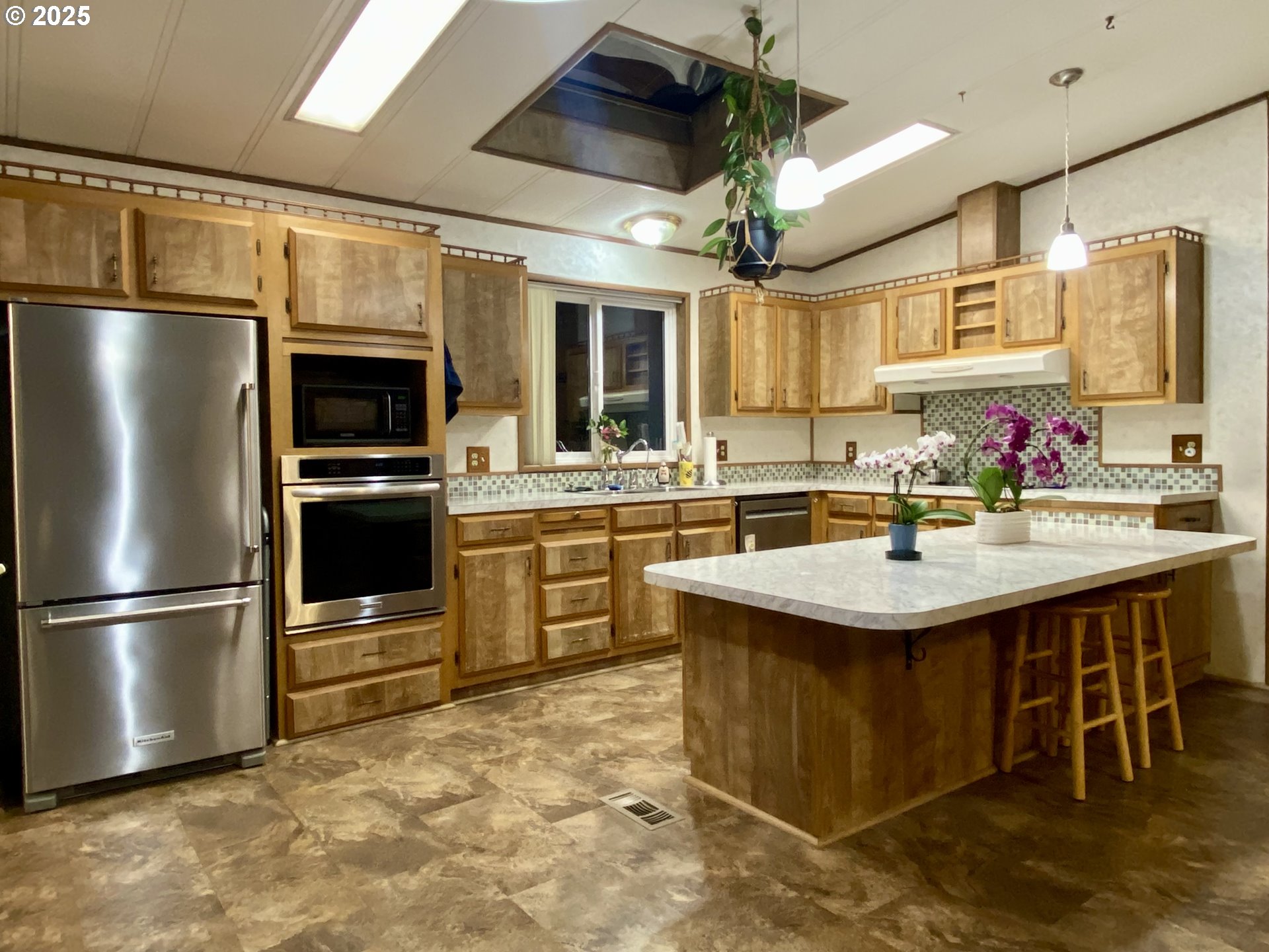 7858 Southeast King Road, Unit 7 Milwaukie, OR 97222 - Photo 31 of 31 a kitchen with a sink stainless steel appliances and cabinets