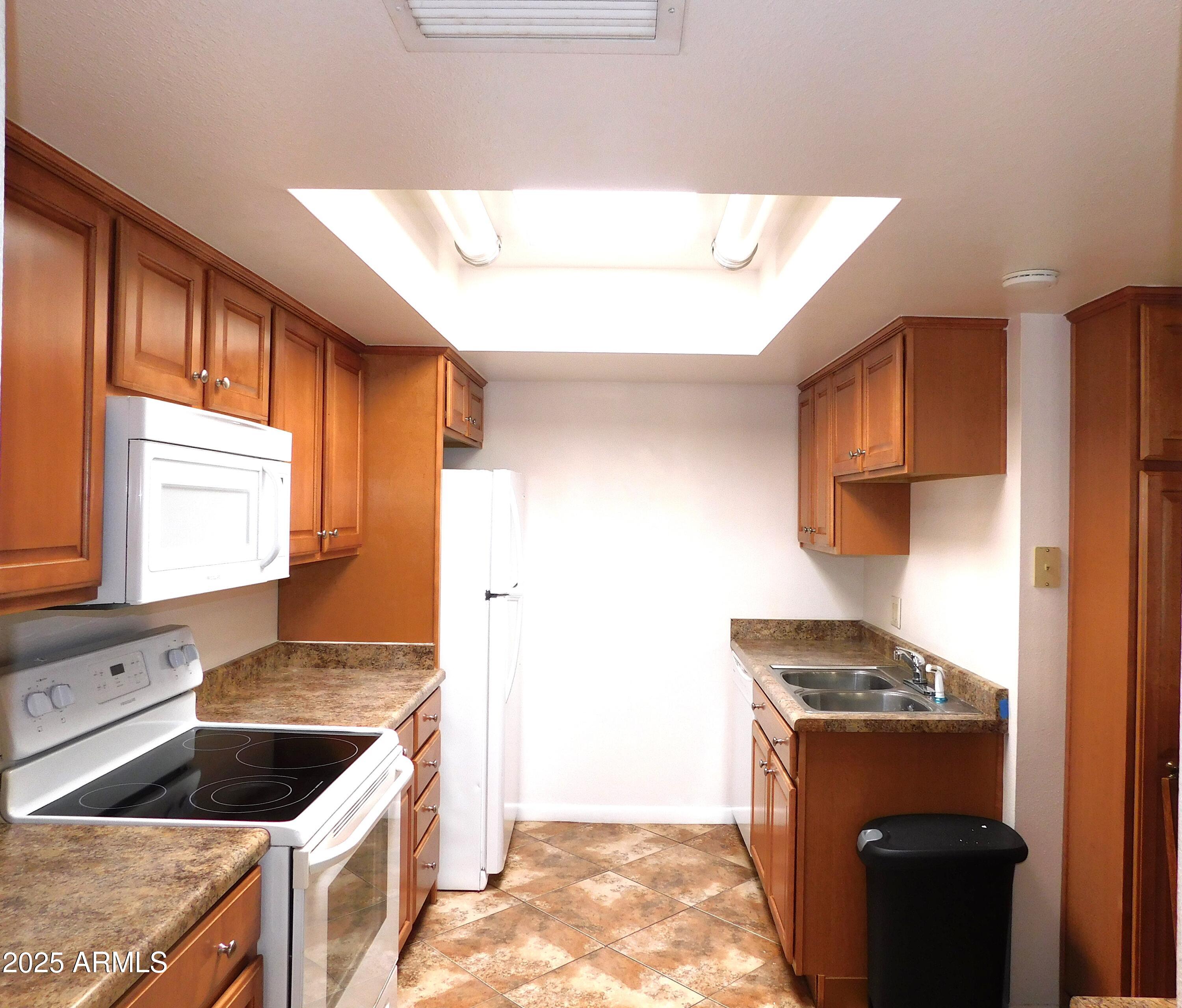 520 South Evergreen Road Tempe, AZ 85288 - Photo 7 of 24 a kitchen with granite countertop a stove and a refrigerator