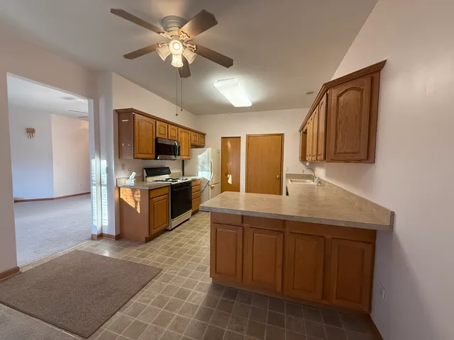 a kitchen with a sink appliances and cabinets