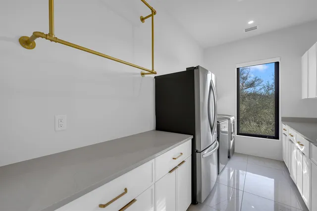 a kitchen with a refrigerator and a window