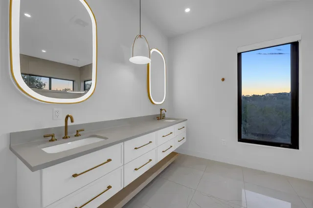 a bathroom with a double vanity sink and a mirror