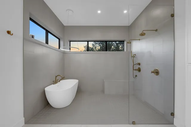 a bathroom with a bathtub and shower