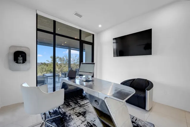 a work room with furniture and a flat screen tv