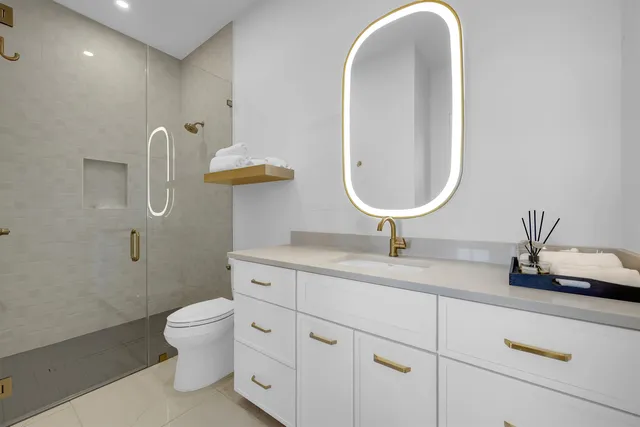 a bathroom with a toilet sink and mirror