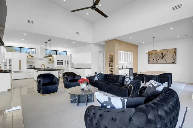 a living room with furniture and a chandelier