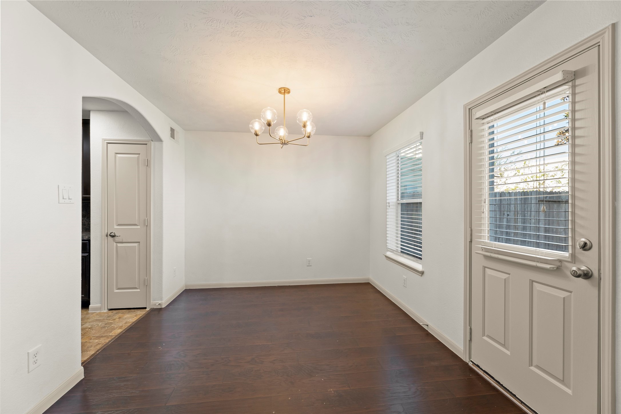 3406 Inverness Path Lane Houston, TX 77053 - Photo 11 of 34 en empty room with windows and chandelier