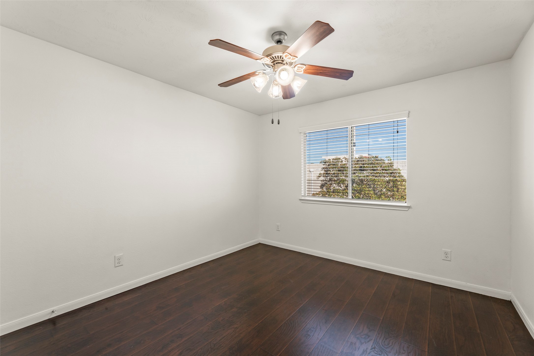 3406 Inverness Path Lane Houston, TX 77053 - Photo 15 of 34 an empty room with wooden floor and ceiling fan