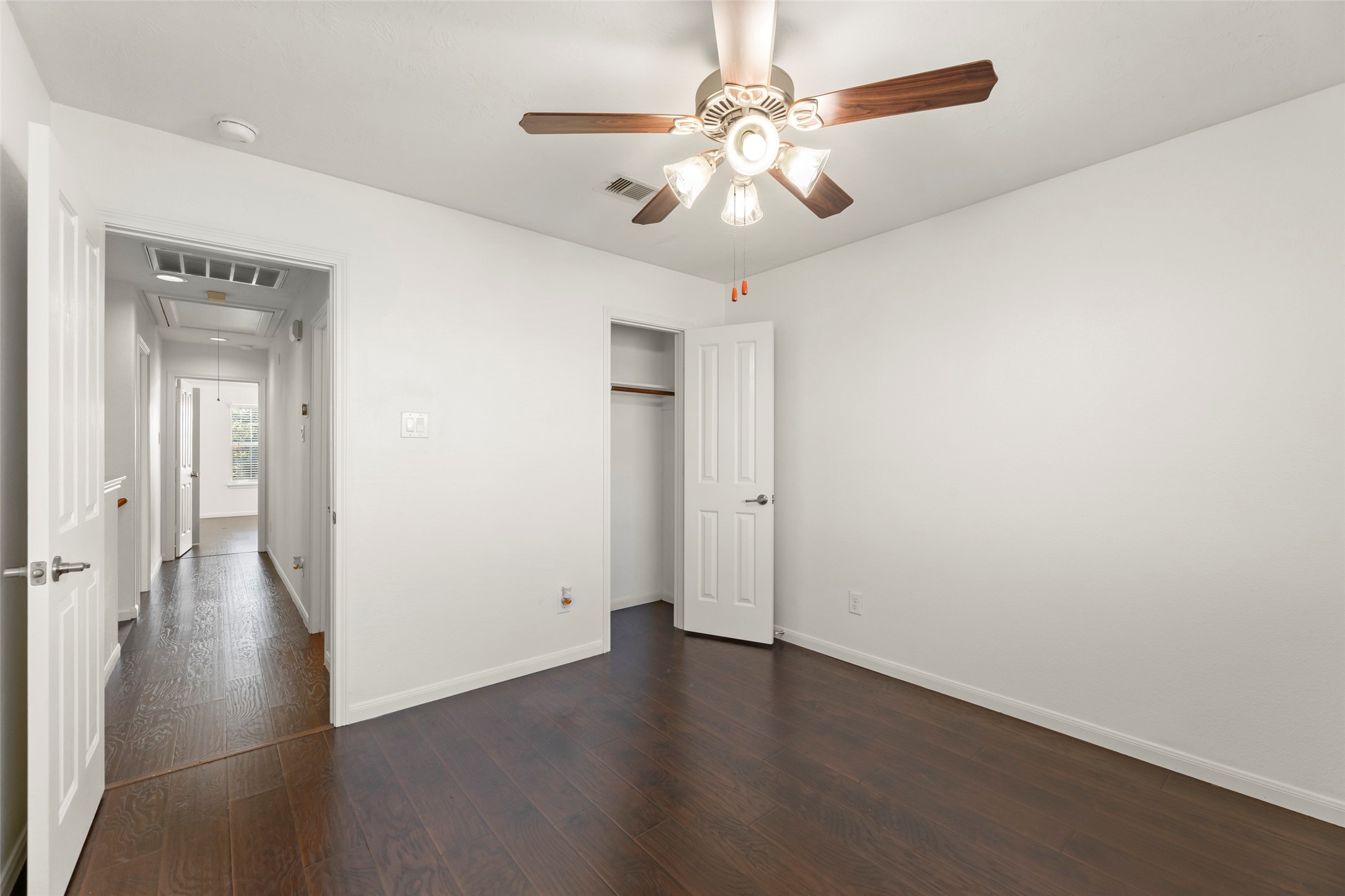 3406 Inverness Path Lane Houston, TX 77053 - Photo 16 of 34 an empty room with wooden floor and ceiling fan