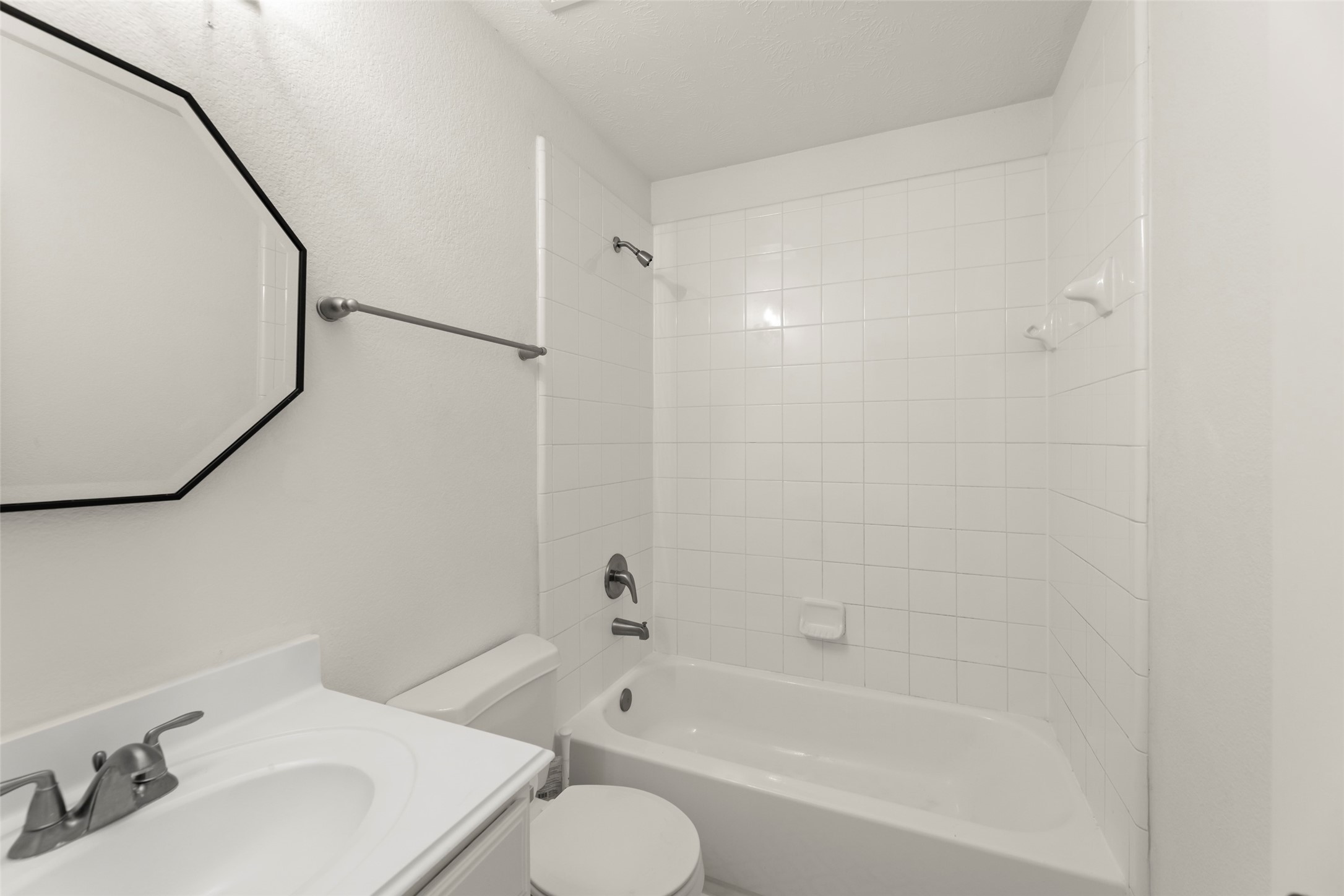3406 Inverness Path Lane Houston, TX 77053 - Photo 17 of 34 a bathroom with a bathtub shower sink vanity and toilet