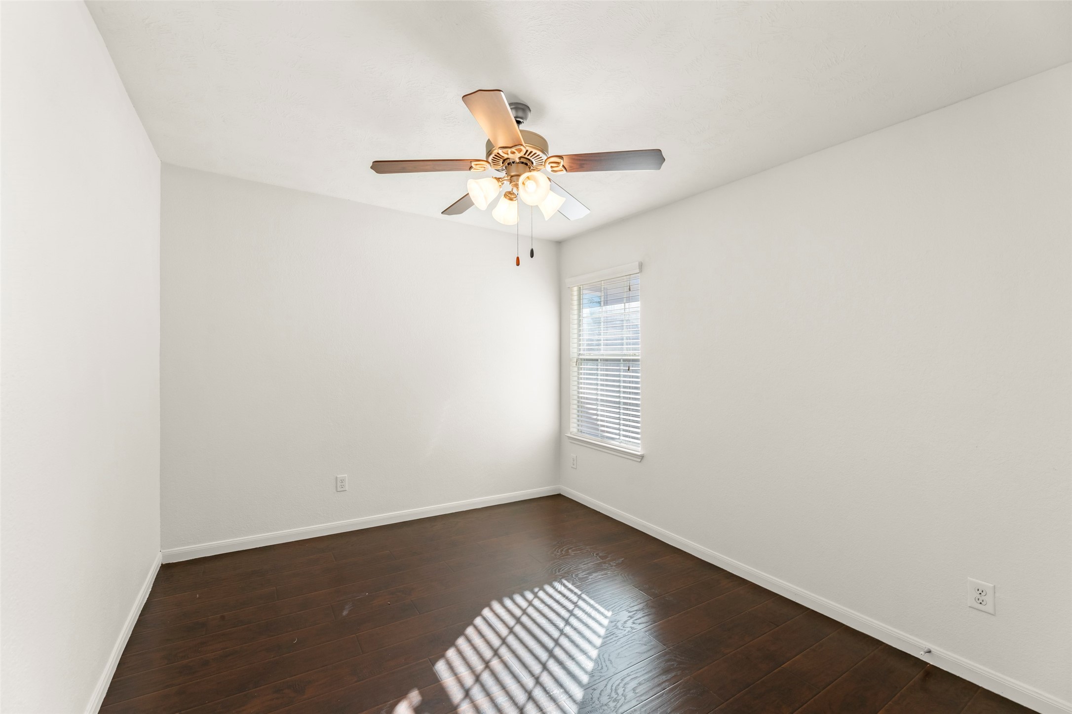 3406 Inverness Path Lane Houston, TX 77053 - Photo 19 of 34 an empty room with windows and fan