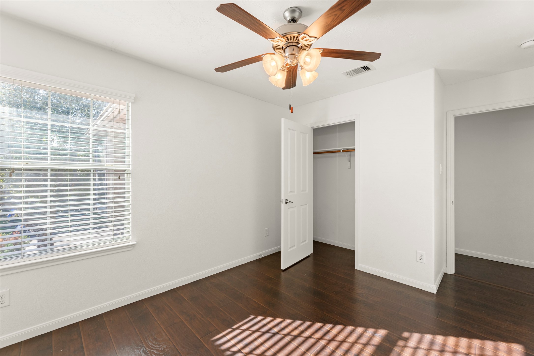 3406 Inverness Path Lane Houston, TX 77053 - Photo 20 of 34 an empty room with wooden floor chandelier fan and windows