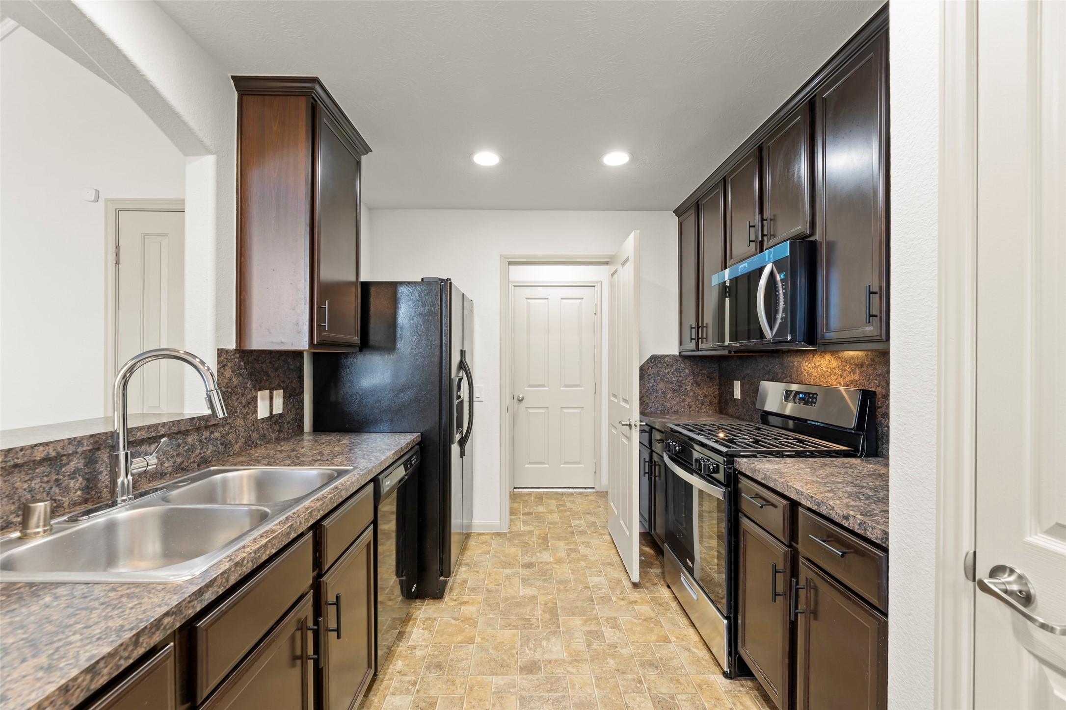 3406 Inverness Path Lane Houston, TX 77053 - Photo 2 of 34 a kitchen with stainless steel appliances granite countertop a sink stove and refrigerator