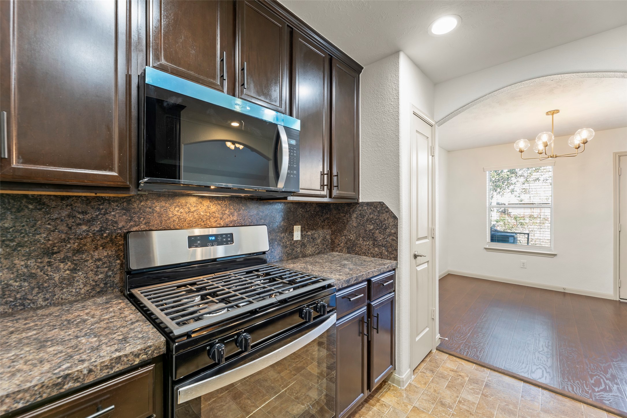 3406 Inverness Path Lane Houston, TX 77053 - Photo 3 of 34 a kitchen with a stove and a microwave