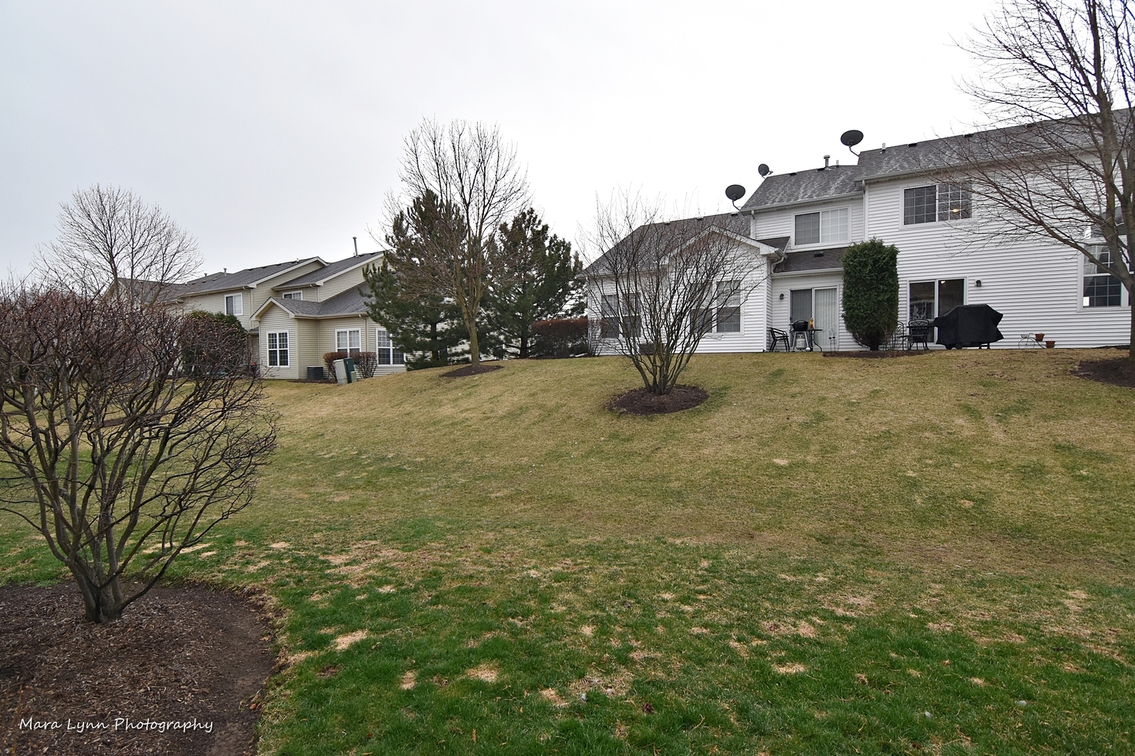 47 Rolling Oaks Road, Unit B Sugar Grove, IL 60554 - Photo 21 of 22 a view of a house with a yard