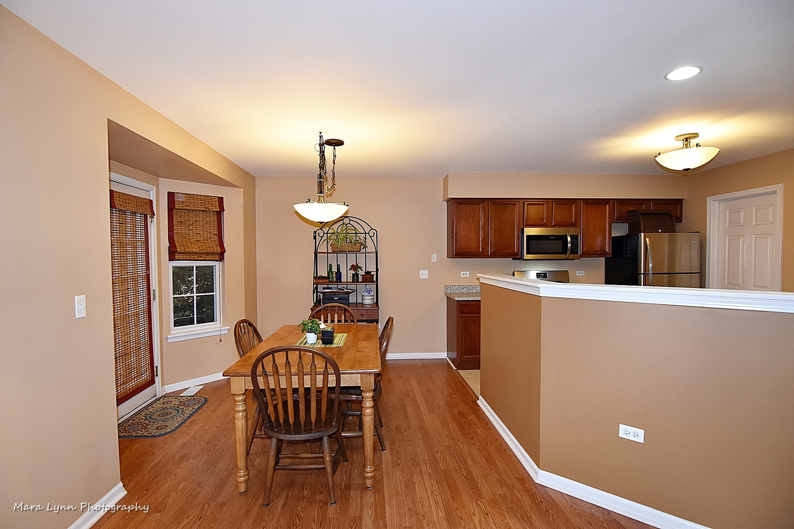 47 Rolling Oaks Road, Unit B Sugar Grove, IL 60554 - Photo 6 of 22 a view of a kitchen with workspace and wooden floor