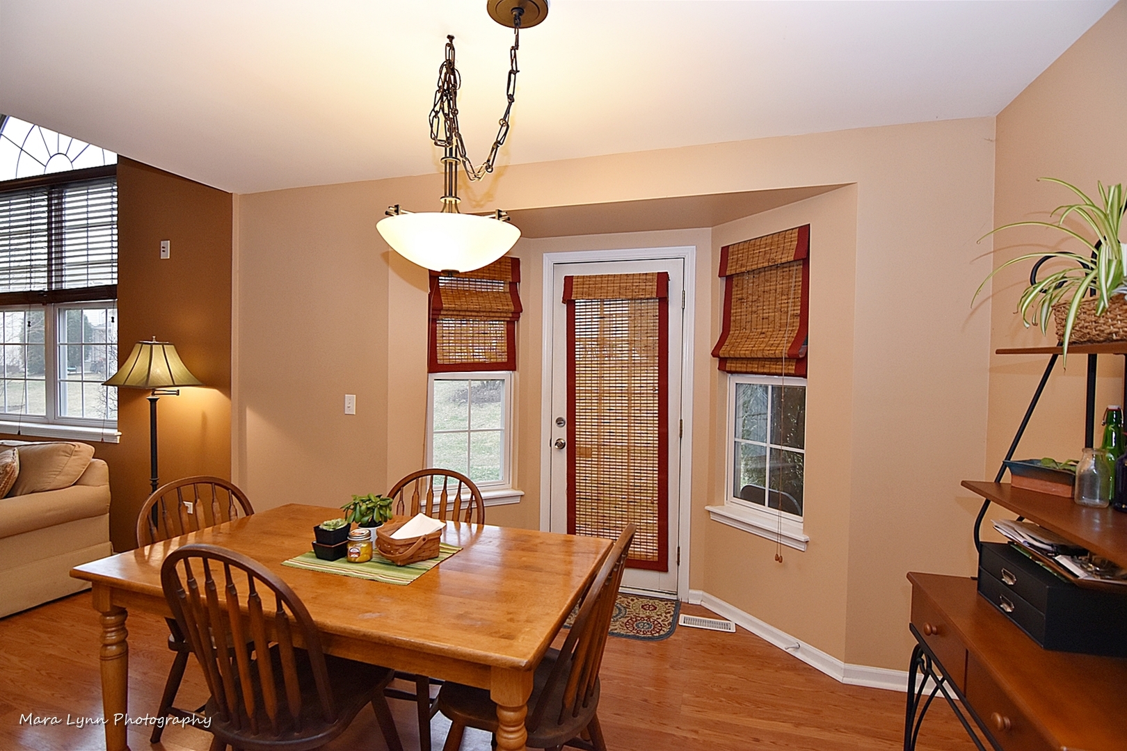 47 Rolling Oaks Road, Unit B Sugar Grove, IL 60554 - Photo 7 of 22 a view of a dining room with furniture a chandelier and wooden floor