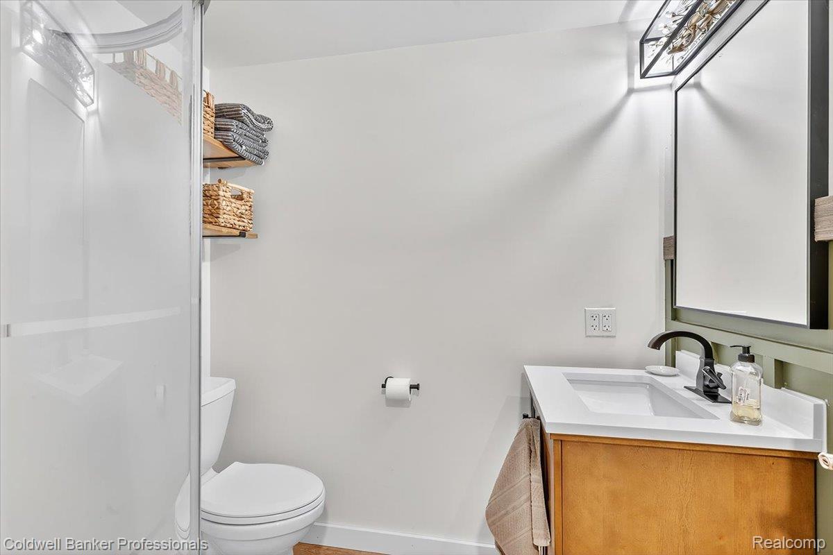 152 South Maple Leaf Road Lapeer, MI 48446 - Photo 15 of 23 Half bath with vanity and toilet