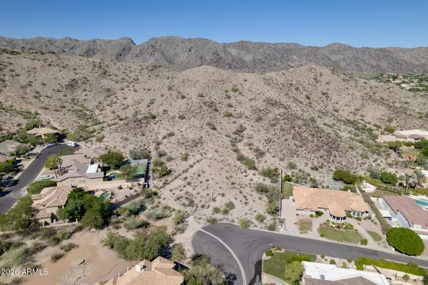an aerial view of a house with a mountain in the background
