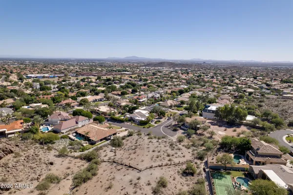 an aerial view of a house with a city