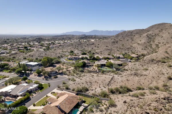 an aerial view of a houses with a city view