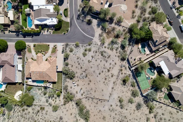 an aerial view of a house with a yard