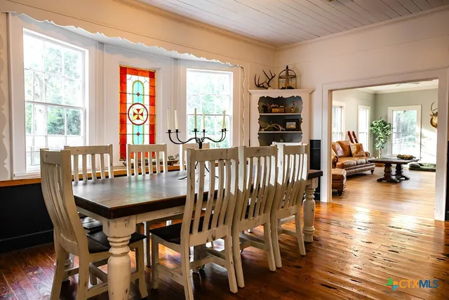 a kitchen with a refrigerator a sink and dishwasher with wooden floor