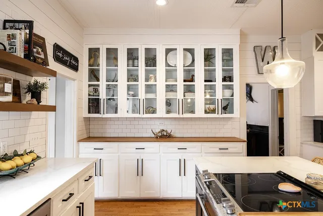 a kitchen with stainless steel appliances a sink a stove and a refrigerator