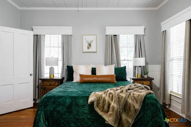 a bedroom with a bed and a television