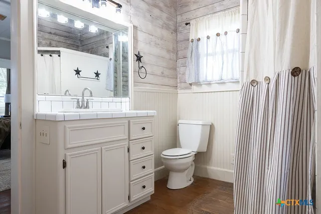 a view of a room with door and wooden floor