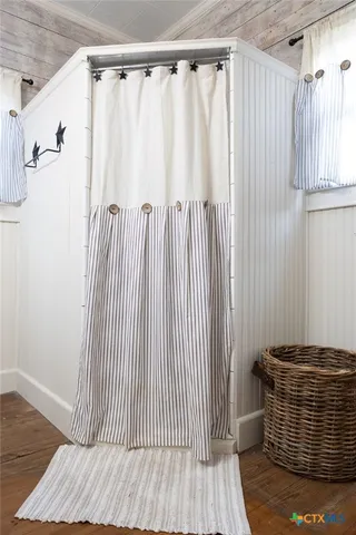 a view of staircase with wooden floor and chair
