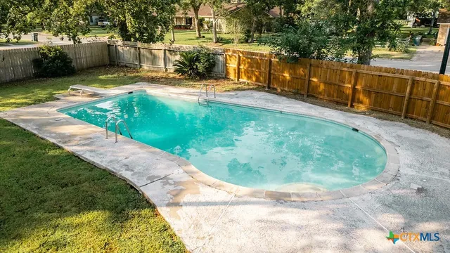 a front view of a house with a yard table and chairs