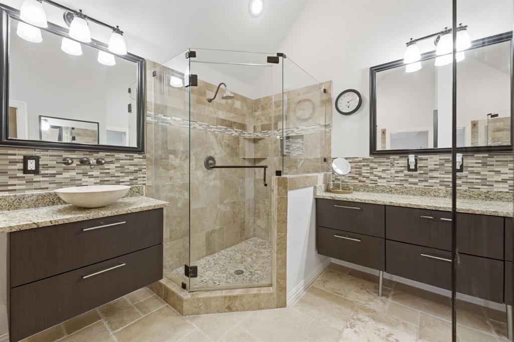 3315 Ricci Lane Irving, TX 75062 - Photo 27 of 40 Dual vanities with stone countertops, vessel sink, and mosaic tile backsplash