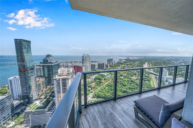 a view of a balcony with two chairs and a table